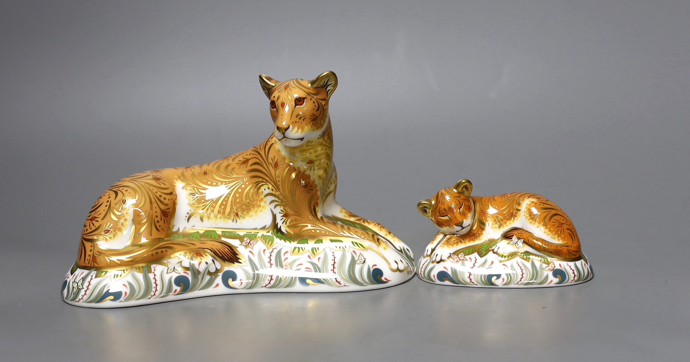 Two Royal Crown Derby paperweights - Lioness, gold stopper, boxed with certificate and Sleepy Lion Cub, gold stopper, boxed with certificate